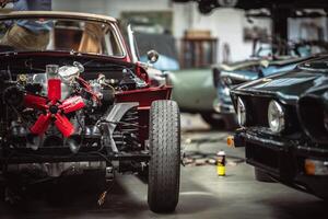 Classic cars being restored in a vintage vehicle garage workshop photo
