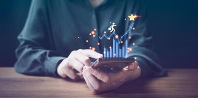 Businesswoman using smartphone to check her business growth photo