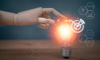 A robot hand is touching a light bulb with icons photo