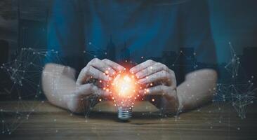 A person holding a light bulb with a network connection photo