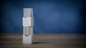 A wooden tower with four blocks on top photo