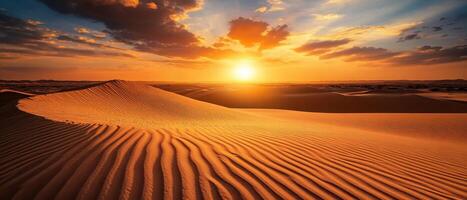 Endless sand dunes at sunset, with deep shadows and glowing orange skies photo