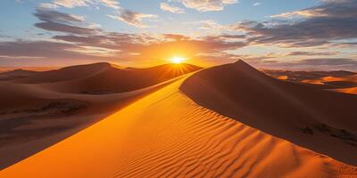 The sun setting behind towering dunes, casting long shadows across the desert photo