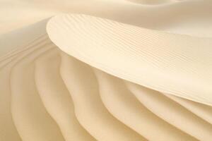 Wind patterns on the sand forming smooth curves, minimalistic desert scene photo