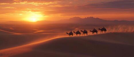 A camel caravan crossing vast desert dunes at dusk, warm light on the sand photo
