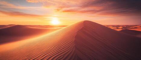 Endless sand dunes at sunset, with deep shadows and glowing orange skies photo