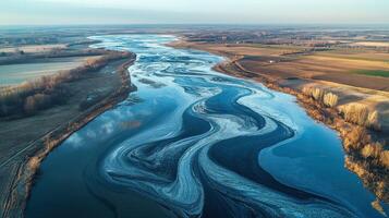 Aerial view of a winding river with ice patterns. photo