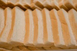 Bread slices are arranged in rows on trays in the hotel restaurant for breakfast. photo
