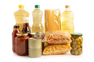 Foodstuff for donation isolated on white background with clipping path, storage and delivery. Various food, pasta, cooking oil and canned food. photo