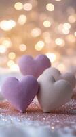 Romantic hearts made from fabric placed on glittering surface, surrounded by sparkling fairy lights and gentle heart-shaped bokeh, light pink and purple tones photo