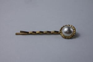 small flower hair clip in gold color photo