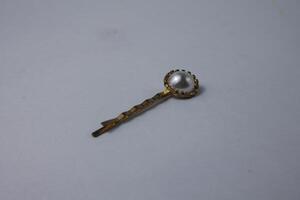 small flower hair clip in gold color photo