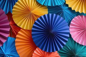 Colorful paper fans creating festive background texture photo