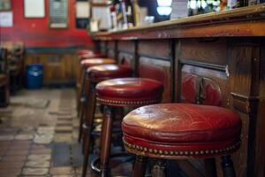 Empty bar stools lined up at the bar waiting for customers photo