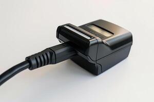 Electronic device being charged with power cord on white background photo