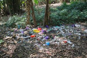 Plastic waste scattered in the yard causes environmental pollution photo
