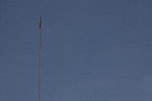 television antenna mast with sky background photo