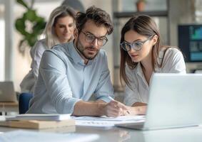 Professional team with an architect and engineers, engaged in a laptop-based construction review photo
