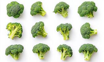 A flat lay of twelve fresh broccoli florets arranged in a grid pattern on a white background. photo