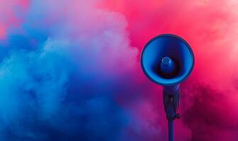 A blue megaphone on a stand in front of a pink and blue smoke background. photo