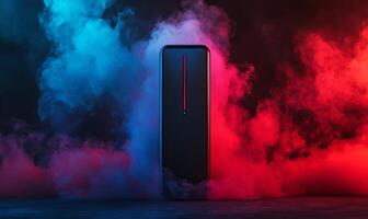A black smartphone with a red line stands in front of a backdrop of blue and red smoke. photo