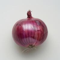 a close up of a red onion on a white surface photo