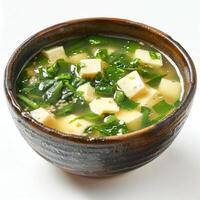 a bowl of soup with tofu and spinach photo