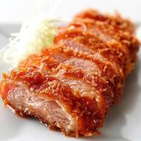 a piece of meat on a plate with a salad photo