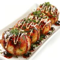 three pieces of food on a plate with sauce and sauce photo