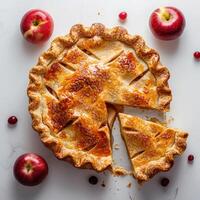 a pie with a slice missing from it and apples around it photo