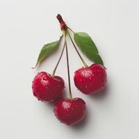three cherries with water droplets on them on a white surface photo