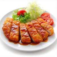 a plate of chicken with sauce and vegetables on it photo