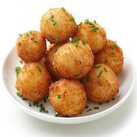 araffy fried tater tots with chives on a white plate photo