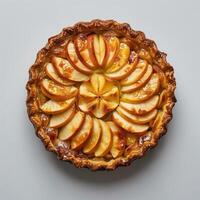a pie with apples on top of it on a table photo