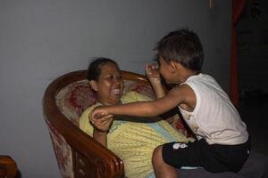 happy expressions of mother and child while joking together photo