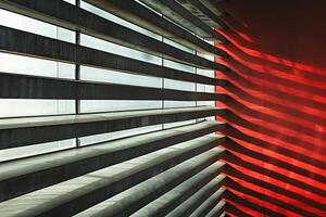 Modern architecture featuring red wall and sunlight shining through window photo