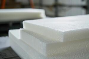 Stack of white polyurethane foam material in a furniture factory photo