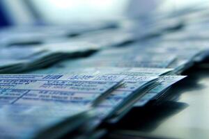 Stack of airplane tickets lying on a table in airport photo