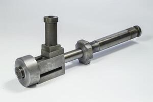 Metal mechanism with screw and nut lying on white background photo