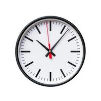 Modern wall clock showing five minutes past twelve o'clock photo