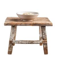 Bowl filled with rolled oats resting on rustic wooden stool photo