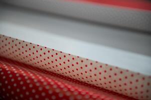 Red and white polka dot patterned wrapping paper rolls create a festive and cheerful atmosphere photo