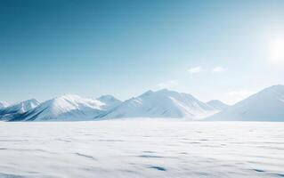 A breathtaking winter landscape featuring majestic snow-capped mountains rising above a vast frozen plain under a clear blue sky photo