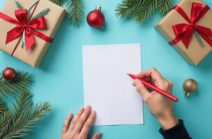 christmas composition with gifts, green fir tree on a blue table. hand writes on blank list of paper, wish list, to do list, shopping list concept, goals and plans for New Year photo