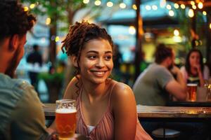 Young woman at a local craft brewery's patio area at twilight, enjoying drinks and the sense of community photo
