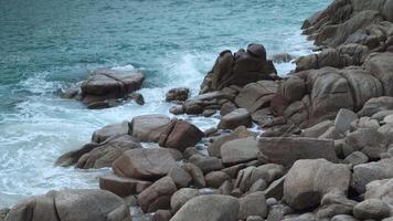 A rocky shore with waves crashing on it video