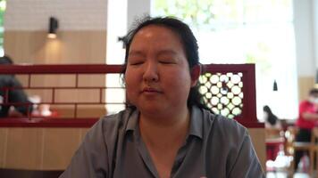 Asian fat woman with a bright face goes about her daily life, eating and walking happily. In the city and in buildings video