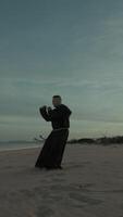 Monk Athlete Does Karate Sport To Defend The Weakest On The Beach video