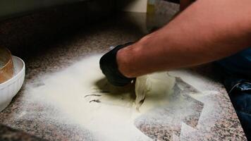 Pizza Chef Is Rolling Out The Block Of Dough On The Marble video