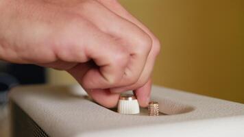 Man's Fingers Touch Switches and Knobs Of A Bluetooth Speaker video
